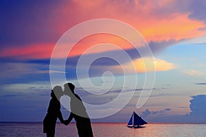 Silhouette of a young bride and groom in beach