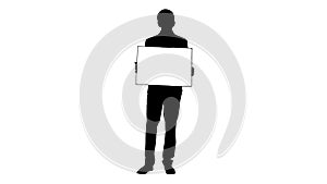 Silhouette Young businessman holding blank sign looking at camer