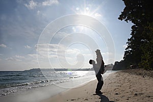 Silhouette of a young couple against  sun glare