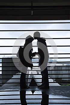 Silhouette of Young Couple Kissing photo