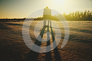 Silhouette of a young couple kissing in the sunset people