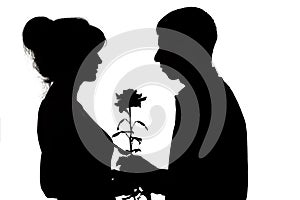 Silhouette of a young couple in love on white isolated background, man gives a woman a rose flower, concept love