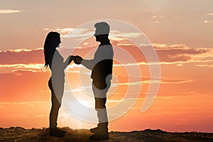 Silhouette of young couple at sunset