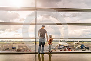 Silhouette of young family, father and daughter on airport terminal