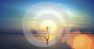 Silhouette of a young girl running along the beach