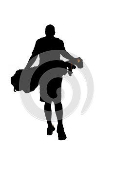 Silhouette of young golfer walking away with golf bag