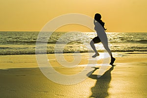 Silhouette of young happy and attractive African American runner woman exercising in running fitness sprint workout at beautiful b