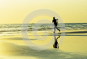 Silhouette of young happy and attractive African American runner woman exercising in running fitness sprint workout at beautiful b