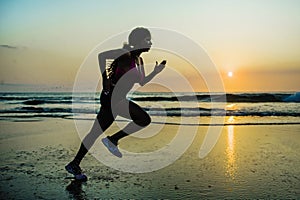 Silhouette of young happy and attractive African American runner woman exercising in running fitness sprint workout at beautiful b