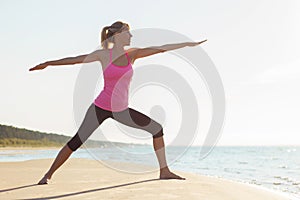 Silhouette of young healthy and fit woman practicing yoga