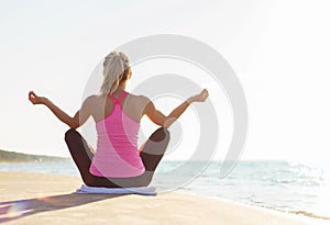 Silhouette of young healthy and fit woman practicing yoga