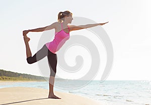 Silhouette of young healthy and fit woman practicing yoga