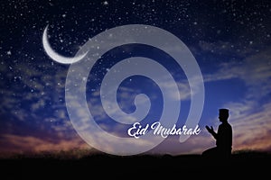 Silhouette young male muslim prayer with hijab praying to God front of landscape view concept for eid mubarak