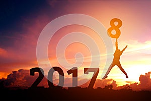 Silhouette young man jumping to 2018 new year