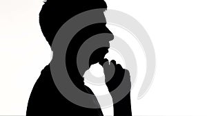 Silhouette of a young man talking and gesticulate, creative person explaining idea on white isolated background, concept lifestyle