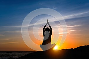 Silhouette young meditation woman practicing yoga.