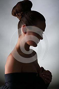 Silhouette of young woman with bare