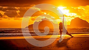 Silhouette of young woman doing yoga on the beach