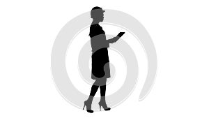 Silhouette Young woman engineer walking with tablet looking at objects around.