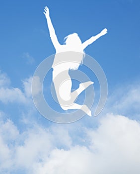 Silhouette of young woman jumping and cheering, arms in the air
