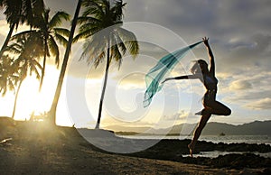 Silhouette of young woman jumping at Las Galeras beach photo