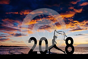 Silhouette young woman jumping to 2018 new year