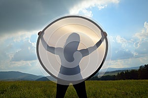 Silhouette of young woman in landscape