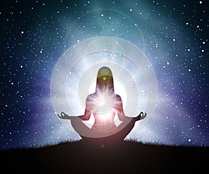 Silhouette of young woman practices yoga and meditates on top of the mountain with night sky, star