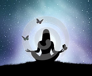 Silhouette of young woman practices yoga and meditates on top of the mountain with night sky, star and butterfly