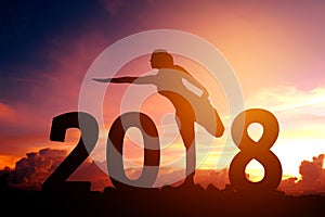 Silhouette young woman practicing yoga on 2018 new year