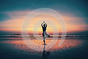 Silhouette young woman practicing yoga on the beach