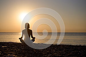 Silhouette young woman practicing yoga on the beach at sunset, Karon Beach ,Phuket ,Thailand. For background and texture