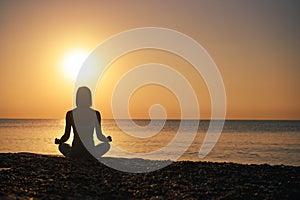 Silhouette young woman practicing yoga on the beach at sunset, Karon Beach ,Phuket ,Thailand. For background and texture