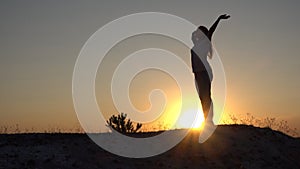 Silhouette young woman practicing yoga and Meditation at sunset