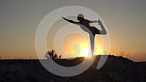 Silhouette young woman practicing yoga and Meditation at sunset