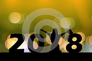 Silhouette young woman sitting on the ground, 2018 new year