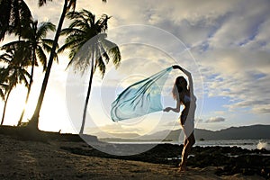 Silhouette of young woman standing at Las Galeras beach