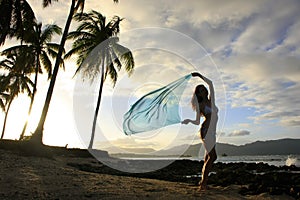 Silhouette of young woman standing at Las Galeras beach photo