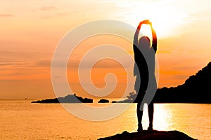 Silhouette of young woman standing at relax pose or freedom pose or chill pose