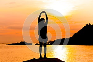 Silhouette of young woman standing at relax pose or freedom pose or chill pose