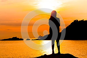 Silhouette of young woman standing at relax pose or freedom pose or chill pose