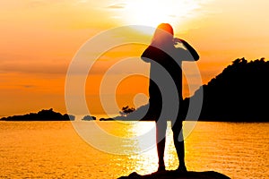 Silhouette of young woman standing at relax pose or freedom pose or chill pose