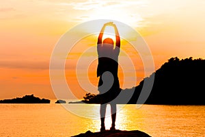 Silhouette of young woman standing at relax pose or freedom pose or chill pose