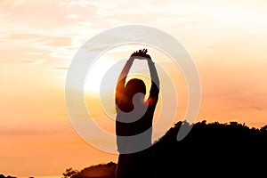 Silhouette of young woman standing at relax pose or freedom pose or chill pose