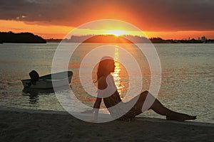 Silhouette of young woman at sunset, Boca Chica bay photo