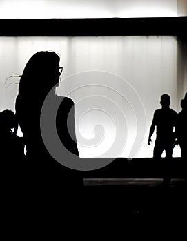 Silhouette of a young woman walking alone in the night