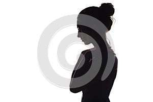 Silhouette of a young woman on a white isolated background, face profile of a beautiful girl