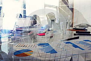Silhouette of young workers in the office with statistic worksheets. concept of teamwork and business. double exposure