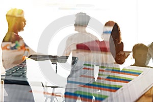 Silhouette of young workers shaking hands in the office. concept of teamwork and partnership. double exposure