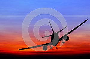 Silhouetted commercial airplane flying